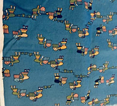 VTG Novelty Folk Art Kokopelli Like Figures Tossed on Meduim Blue 21″x17″