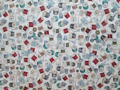 THREAD SPOOLS OF THREAD ON CREAM COTTON FABRIC FQ