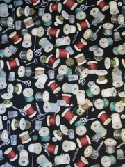 THREAD SPOOLS OF THREAD ON CREAM COTTON FABRIC FQ