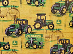 John Deere Cotton Fabric Distressed Yellow Background W/ Tractors and Barns 1 yd