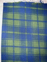Blue/green plaid in medium weight looser weave synthetic fiber, 38″Lx54″W