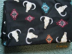 Cow skulls on black background from Timeless Treasures