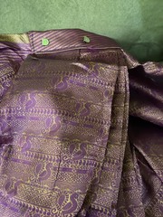 4 yards of fabric purple and gold, patterned, clips on top in the middle
