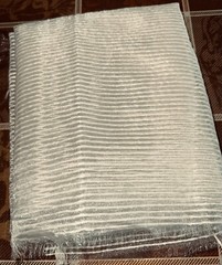 Cream ribbed woven polyester transparent 20″Lx60″W remnant, quite “sparkly”