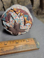 Handcrafted pieced fabric ball star pattern brown gold tones