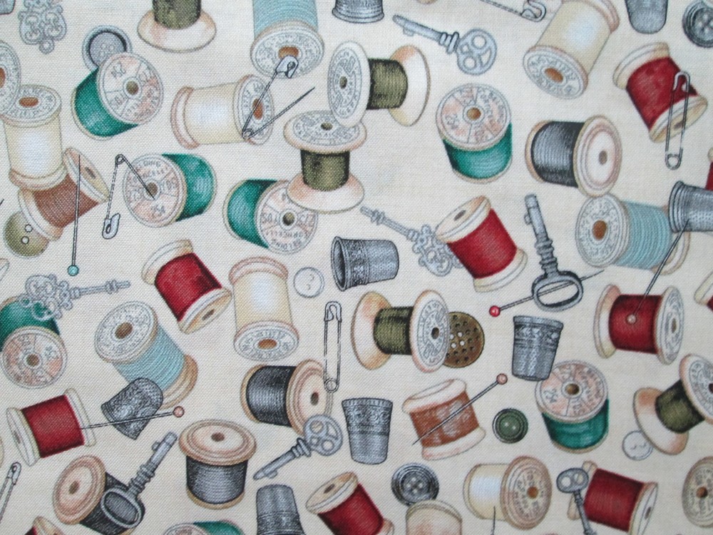 THREAD SPOOLS OF THREAD ON CREAM COTTON FABRIC FQ