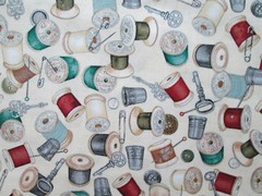 THREAD SPOOLS OF THREAD ON CREAM COTTON FABRIC FQ