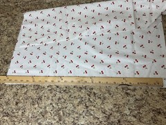 Red Cherries with Green Leaves on White with small Polka Dots Background