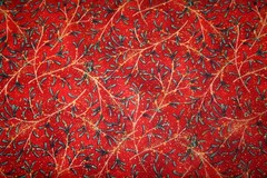 WINTER’S NIGHT-CHRISTMAS GREENERY ON RED FROM MAYWOOD – 100% COTTON FABRIC