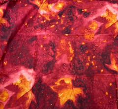 FABRI-QUILT #D108 FALL LEAVES ON MOTTLED RED- COTTON 30″ X 44″(OVER 3/4 YARD)