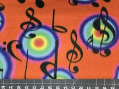 MUSIC NOTE NOTES RAINBOW BURST ON RED FLEECE FABRIC 1 YARD 36″ X 60″