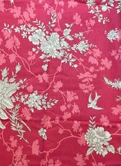 Notting Hill. Tan floral fabric on muted red background. Sold by the yard.
