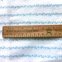 White fqbric with tiny blue flower stripes 24″ x 29″ $4