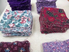 l.12 LBS VINTAGE LOT VARIOUS FABRICS CUT INTO 3.5″ SQUARES – MOST PURPLE COLORS