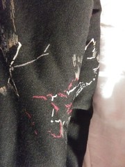 black knit fabric with red,tan,grey and gold