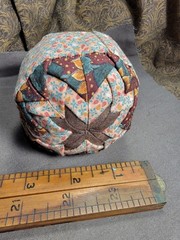 Handcrafted pieced fabric ball star pattern brown gold tones