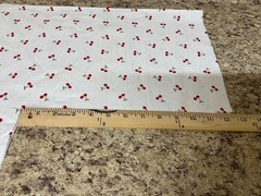 Red Cherries with Green Leaves on White with small Polka Dots Background