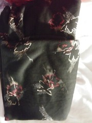 black knit fabric with red,tan,grey and gold