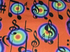 MUSIC NOTE NOTES RAINBOW BURST ON RED FLEECE FABRIC 1 YARD 36″ X 60″