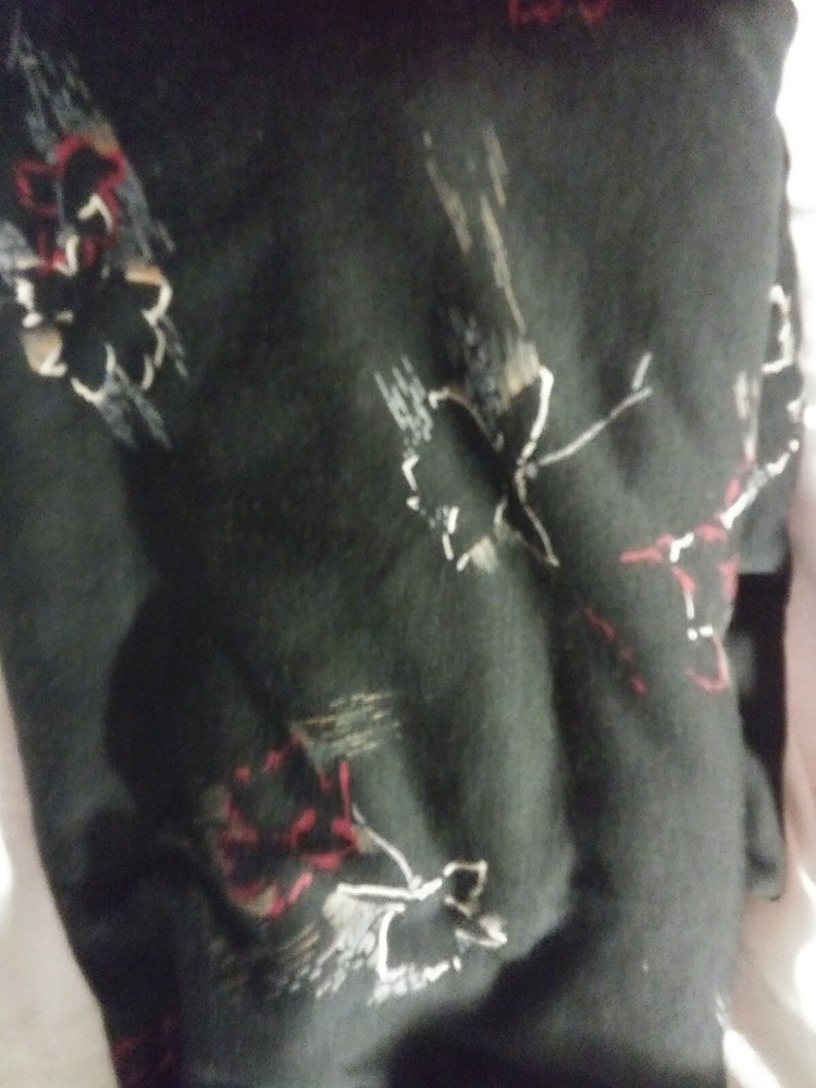 black knit fabric with red,tan,grey and gold