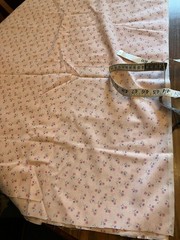 pink calico print fabric. 44 inches wide. 60 inches long except for a 10×14 in