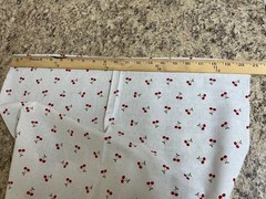 Red Cherries with Green Leaves on White with small Polka Dots Background
