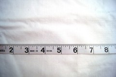 1 Yard Textured White Plastic with Flannel Back Tablecloth Fabric 35″ X 54″