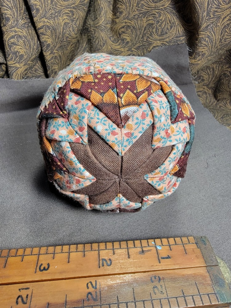 Handcrafted pieced fabric ball star pattern brown gold tones