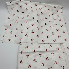 Red Cherries with Green Leaves on White with small Polka Dots Background