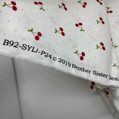 Red Cherries with Green Leaves on White with small Polka Dots Background