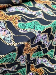 Snake print, Animal print, Jersey Knit Fabric. GREEN ORANGE STRETCH FABRIC Black