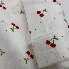 Red Cherries with Green Leaves on White with small Polka Dots Background