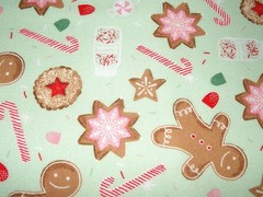 Flannel print scattered with iced Christmas cookies candy canes and gingerbread