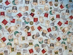 THREAD SPOOLS OF THREAD ON CREAM COTTON FABRIC FQ