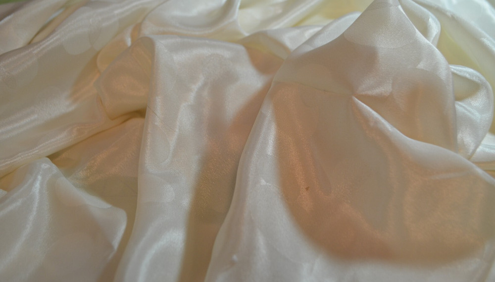 cream polyester jacquard fabric, circles 90 L” x 44″ W (2.5 yds)