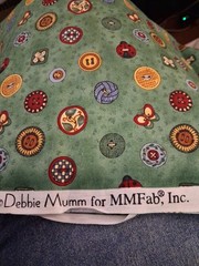 1 yard Debbie Mumm sewing buttons on green cotton 44″ wide