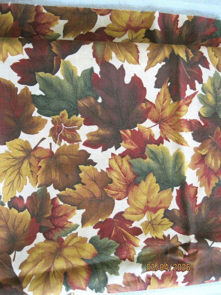 Brown, green, red and tan leaves on tan background from Cranston Print Works