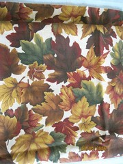 Brown, green, red and tan leaves on tan background from Cranston Print Works