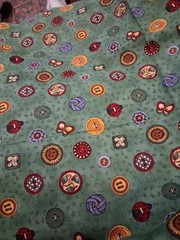 1 yard Debbie Mumm sewing buttons on green cotton 44″ wide