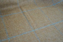 Tweed material by the metre in light brown/beige with windowpane in blue fabric