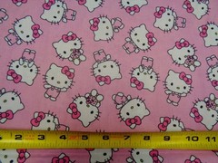 HELLO KITTY TOSSED DESIGN ON PINK BACKGROUND 100% COTTON 1/2 YARD PIECE
