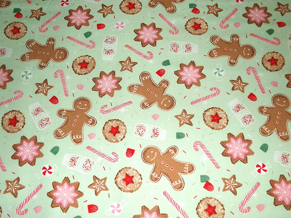 Flannel print scattered with iced Christmas cookies candy canes and gingerbread