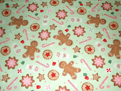 Flannel print scattered with iced Christmas cookies candy canes and gingerbread
