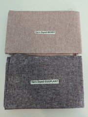 2 pieces of yarn-dyed fabric, 19 x 42″, eggplant and berry reversible.