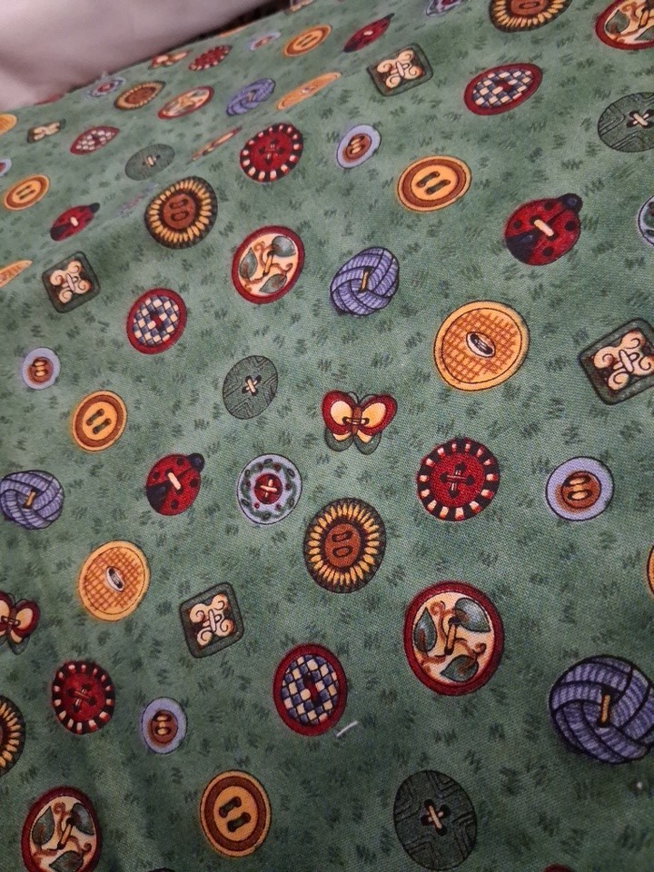 1 yard Debbie Mumm sewing buttons on green cotton 44″ wide