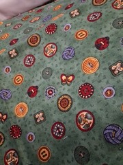 1 yard Debbie Mumm sewing buttons on green cotton 44″ wide